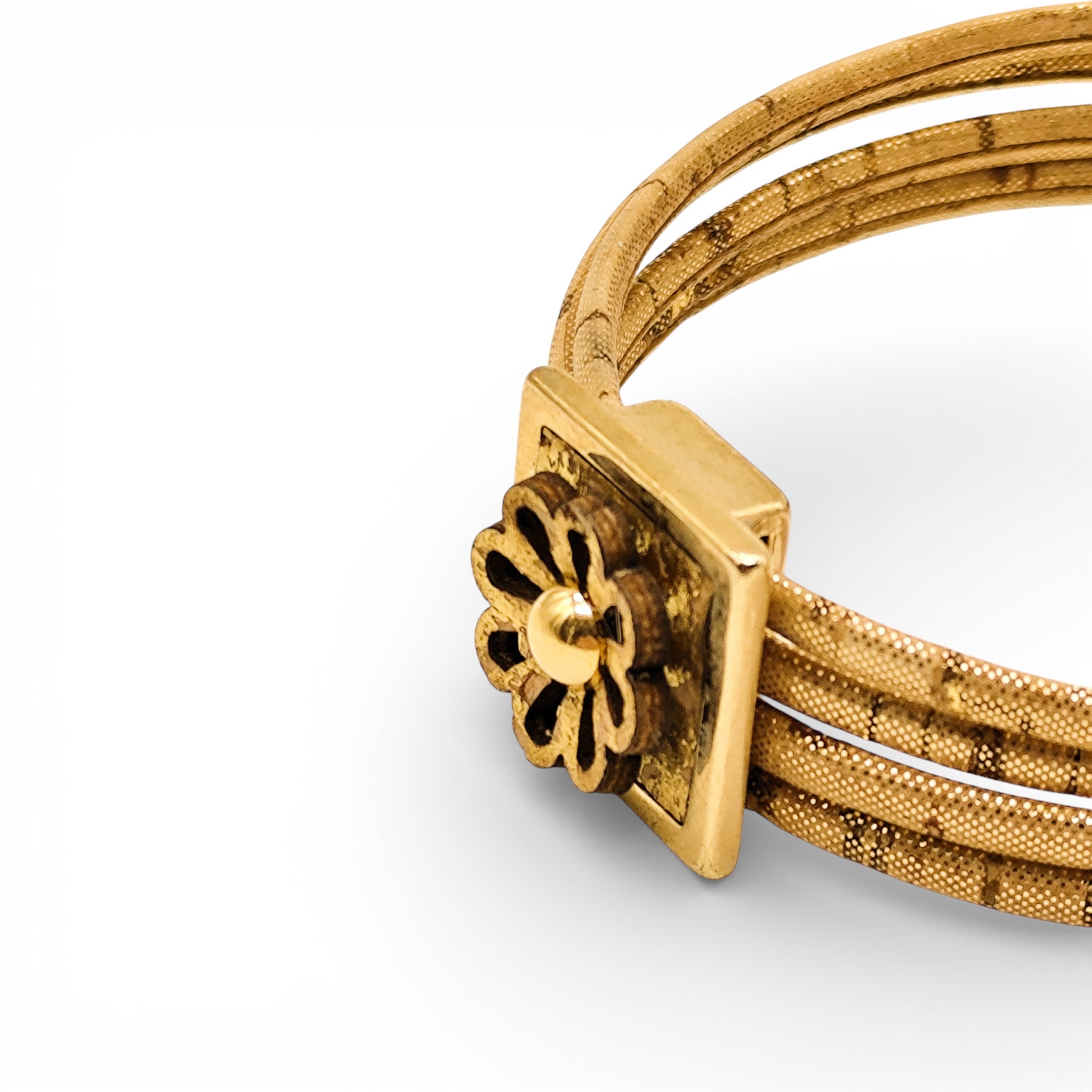 Artipel women's natural cork bracelet with golden flower detail and magnetic closure, showcasing elegant design and texture.