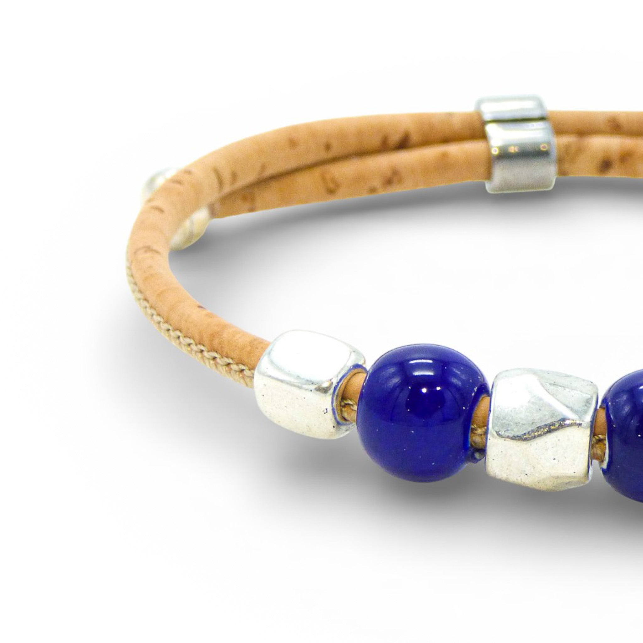 Delicate Cork Colors bracelet with blue pearl accents and a silver clasp, showcasing a minimalist design.