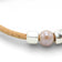 Delicate rose-hued Cork Colors bracelet with pearl accents and silver clasp, showcasing a fine jonc design.