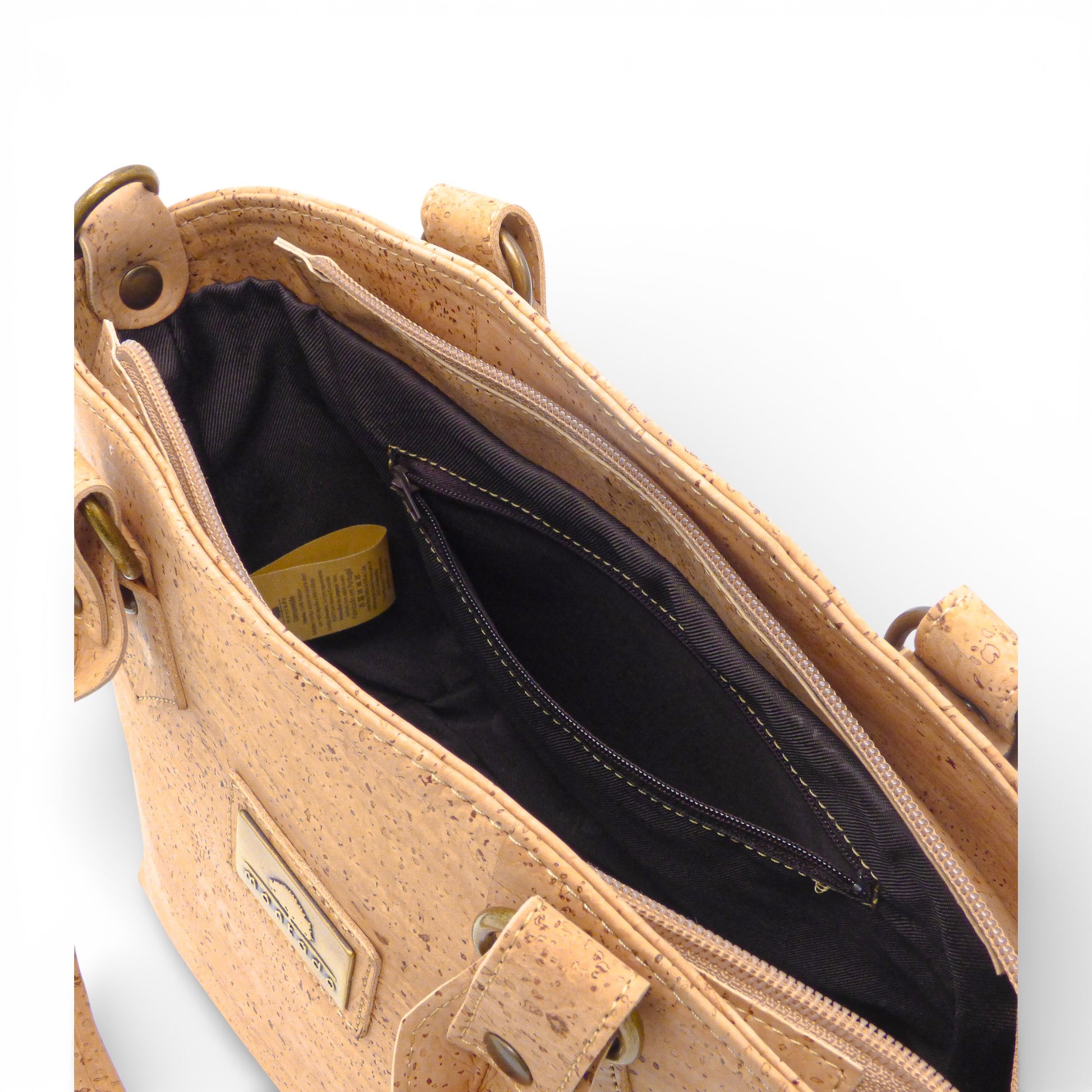 Interior zip pocket detail of Montado vegan cork tote bag, showcasing trendy design and practical storage.