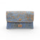 Front view of Montado Double Poche pochette in blue with relief and gold accents, showcasing its practical multi-pocket design.