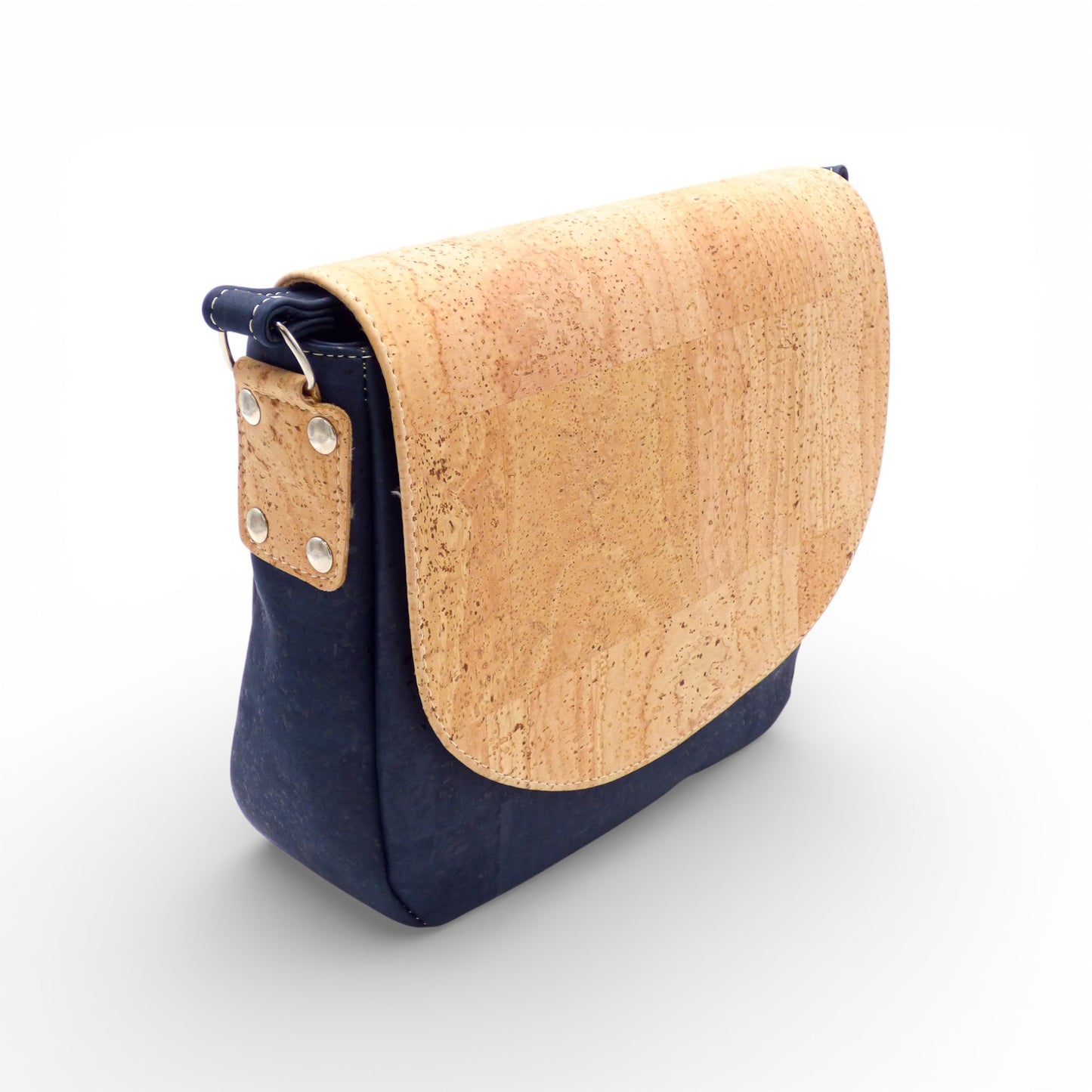 Bicolore "Grand Rabat" shoulder bag by Amador Varum, featuring a natural cork body and dark blue flap, adjustable strap.
