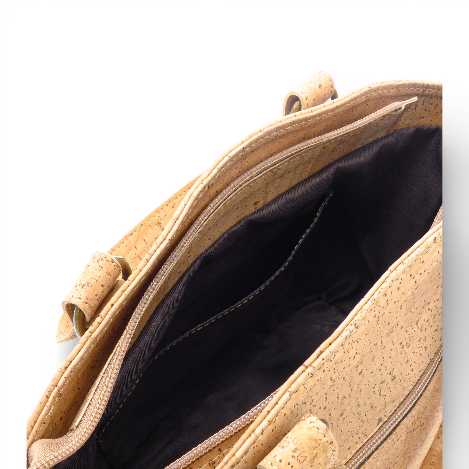 Interior view of Montado cork bag showing dark fabric lining and detailed stitching.